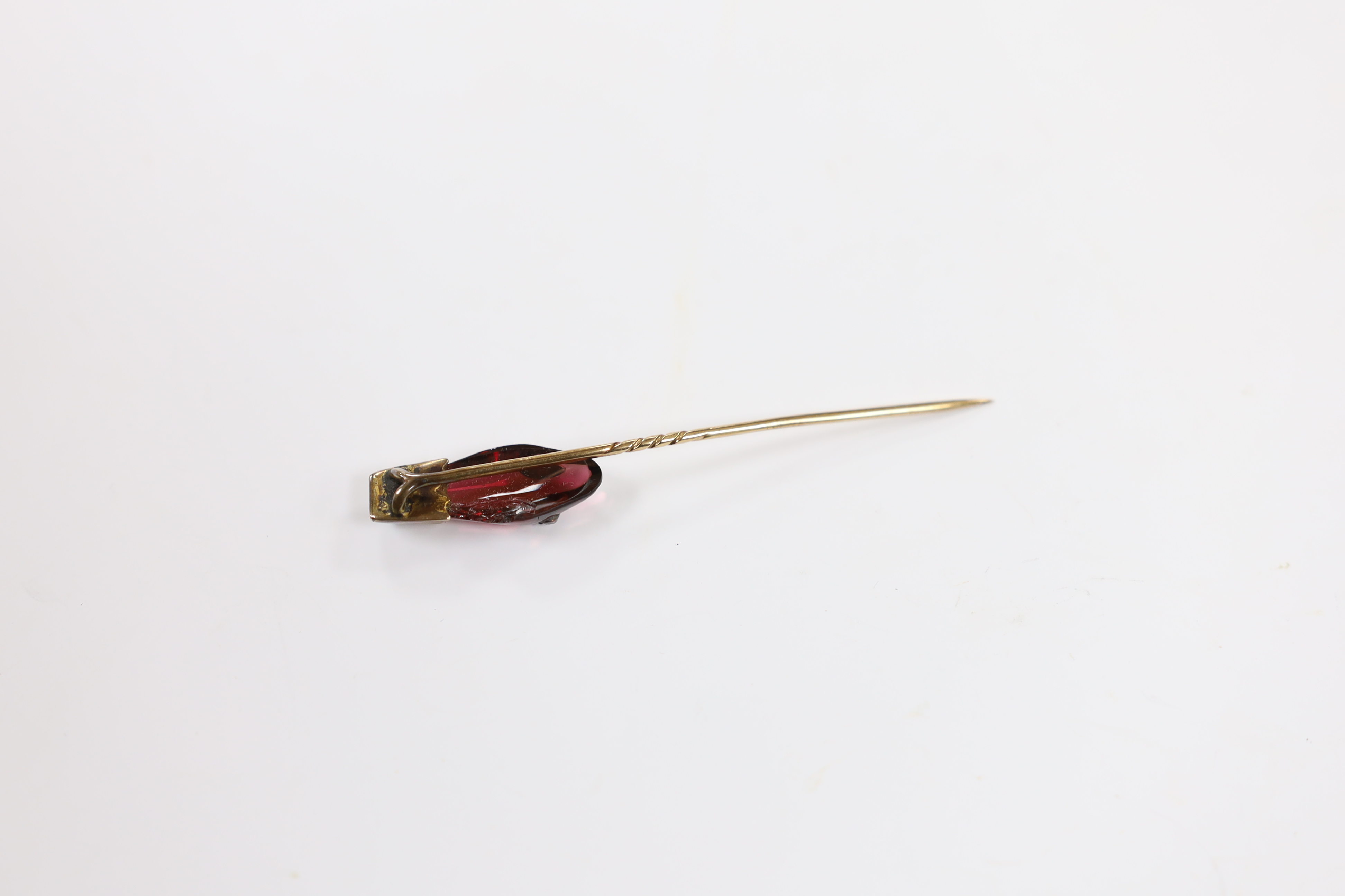 A late Victorian yellow metal, garnet and diamond set serpent head stick pin, 65mm, gross weight 2.9 grams (chip).